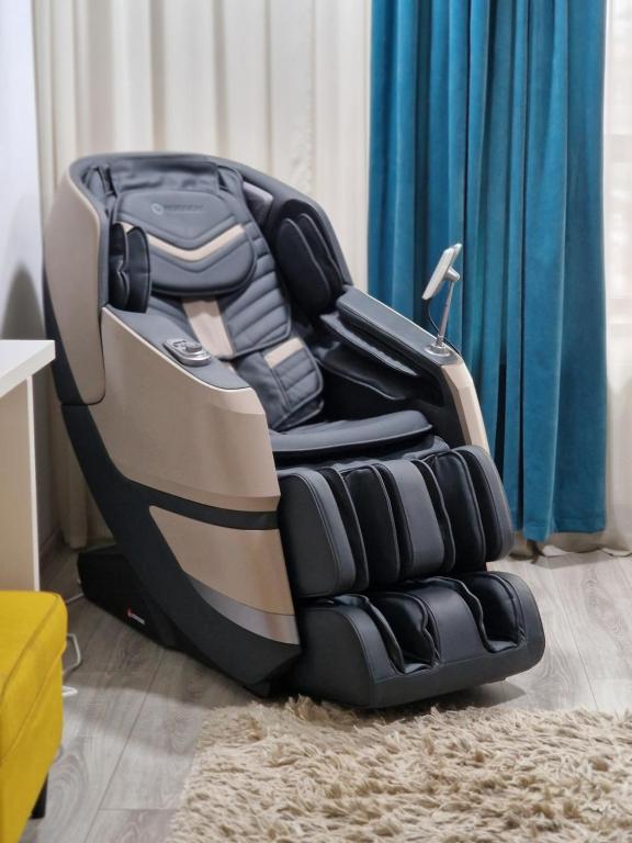 a car seat sitting on the floor in a room at Unique Hotel Apartments Rond Vechi in Iaşi