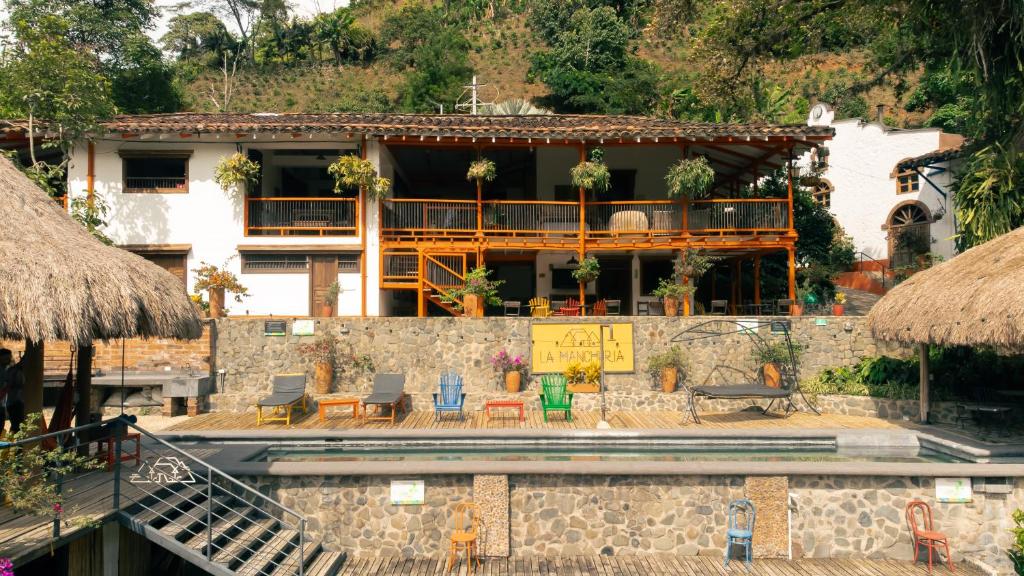 a building with a pool in front of it at Finca La Manchuria in Salgar