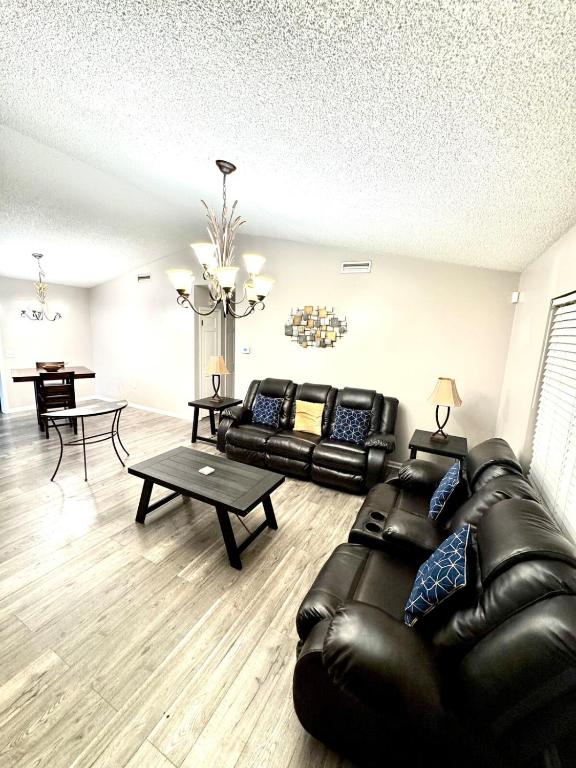 a living room with a leather couch and a table at Home Away from Home in Fitzgerald
