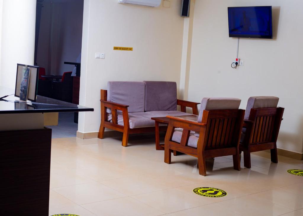 a room with chairs and a table and a television at cyro reservations in Nalakonge