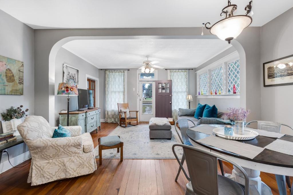 a living room with a table and a dining room at Bluebird Cottage, 1897 Home On Salida's Alpinepark in Salida
