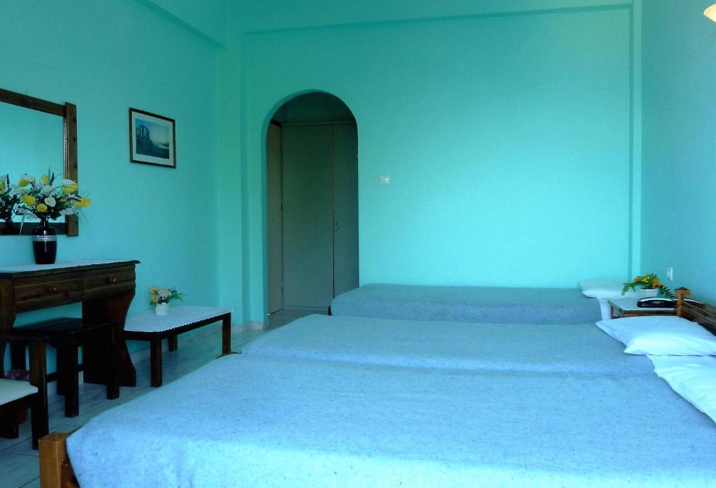 Postel nebo postele na pokoji v ubytování Hotel Perama