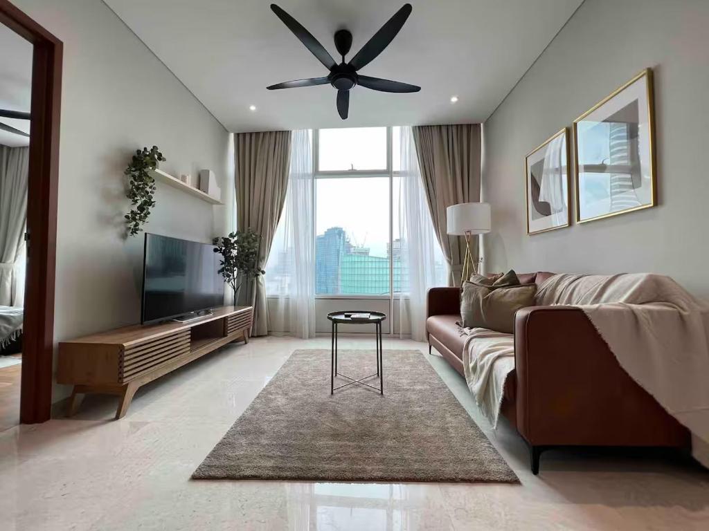 a living room with a couch and a ceiling fan at Luxury Suites Twin Tower in Kuala Lumpur