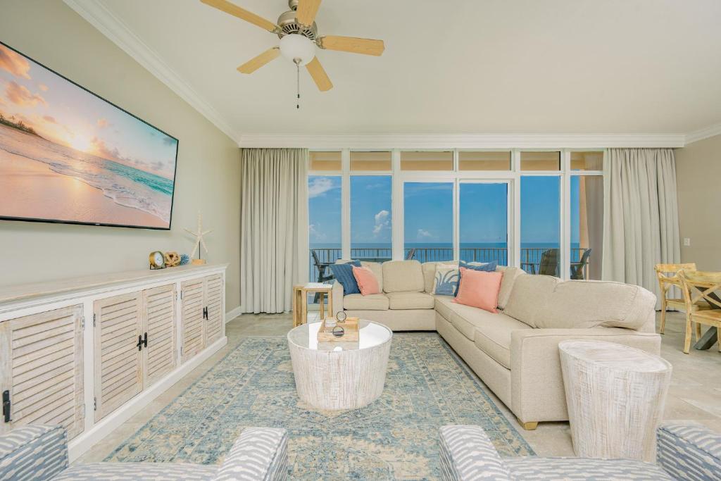 a living room with a couch and a table at Phoenix Orange Beach II 1603 condo in Orange Beach