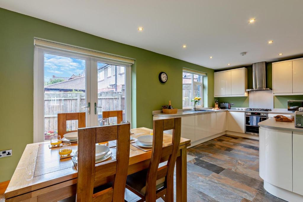 a kitchen with a wooden table and a large window at Blue Crab House - Tynemouth in Tynemouth