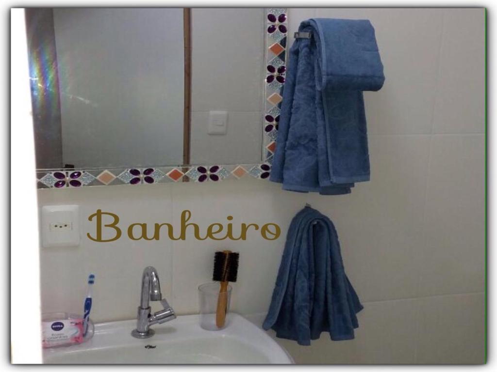 a bathroom with a sink and a mirror at Pousada Lilás in Angra dos Reis