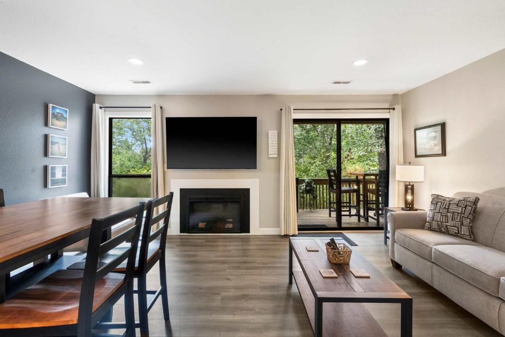 a living room with a table and a fireplace at Top Notch - Condo for 6 in Branson