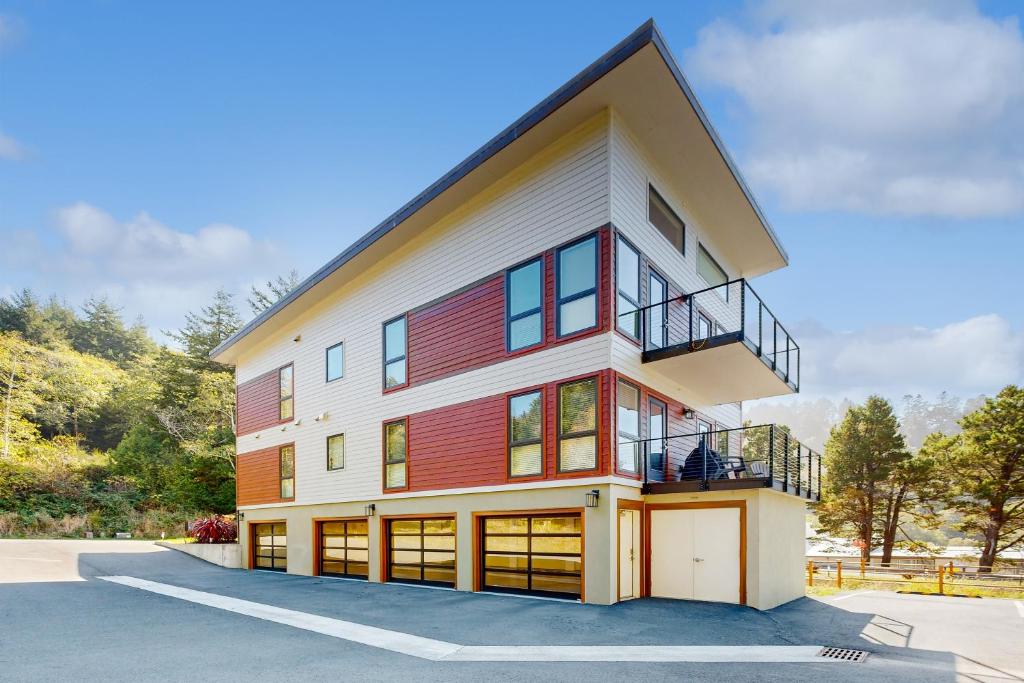 a house with a red and white building at Serenity at Deerhaven #B in Gold Beach