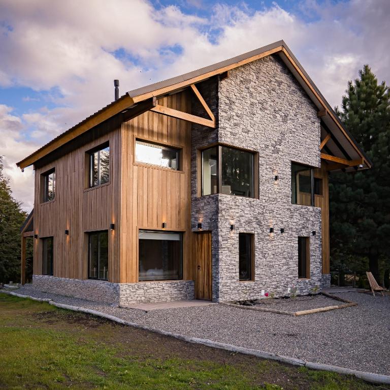 a house being constructed with a stone and wood at 4Puntas Lodge in Lago Meliquina