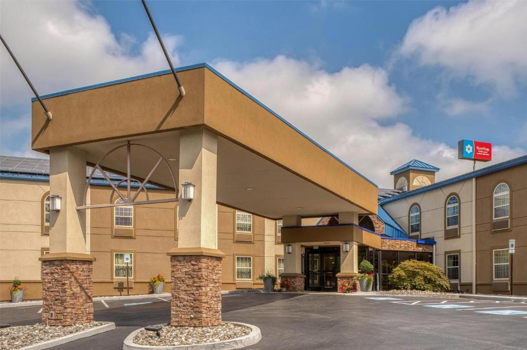 a hotel front of a building with a roof at SureStay Plus Hotel by Best Western Elizabethtown Hershey in Elizabethtown