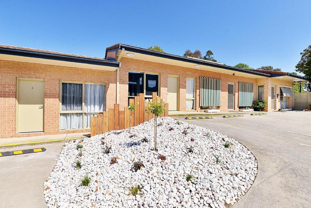 a large pile of rocks in front of a building at Cranbourne Motor Inn in Cranbourne