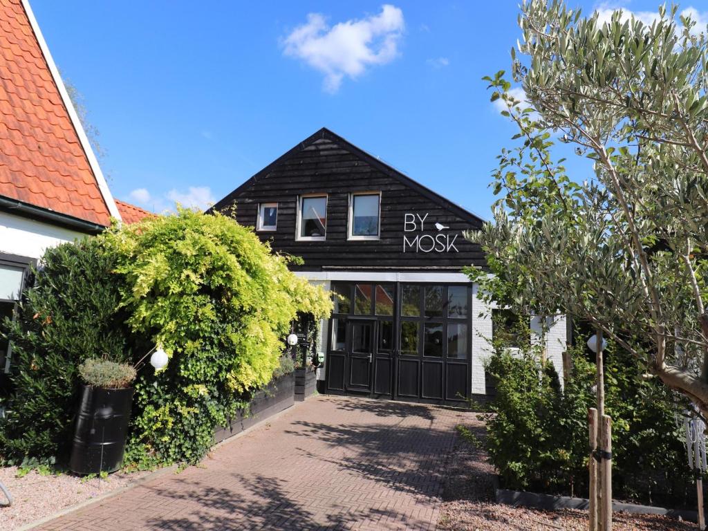 a black and white building with a garage at Beautifully styled apartment in Engelum