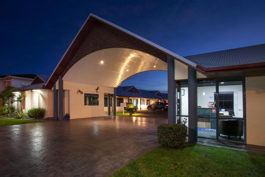 een huis met een grote boog ervoor bij ASURE Albert Park Motor Lodge in Te Awamutu