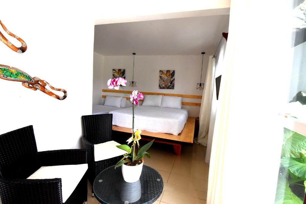 a bedroom with a bed and a table and chairs at Freddy`s Place B&B in Monteverde Costa Rica