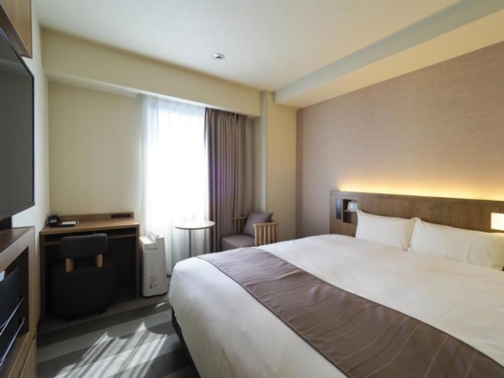 a hotel room with a large bed and a television at Far East Village Hotel Yokohama - Vacation STAY 35241v in Yokohama