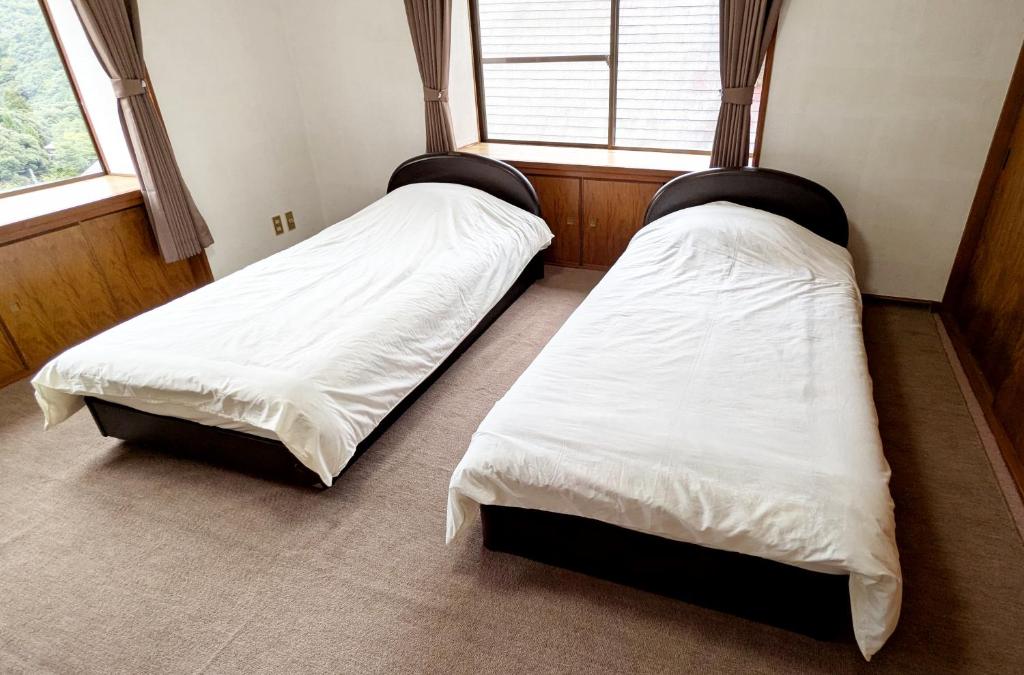 Ένα ή περισσότερα κρεβάτια σε δωμάτιο στο コテージ自給自足 伊根