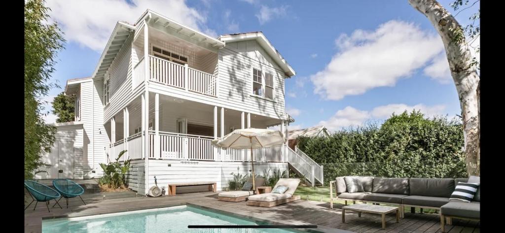 a house with a swimming pool in front of a house at 6 Bedroom Californian Bungalow in Melbourne