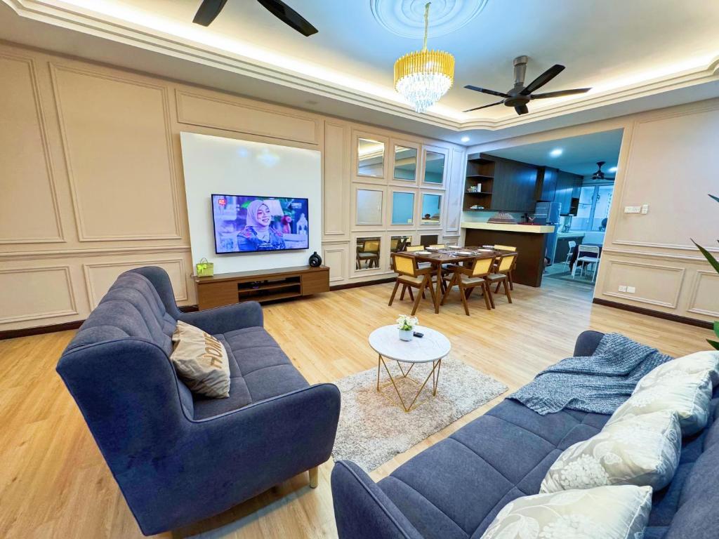a living room with a blue couch and a table at KLIA Sepang Salak Dream Retreat Homestay in Sepang