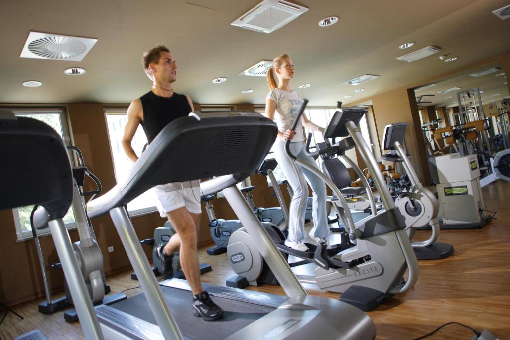 a man and woman on a treadmill in a gym at Hotel Neptun - Terme & Wellness Lifeclass in Portorož