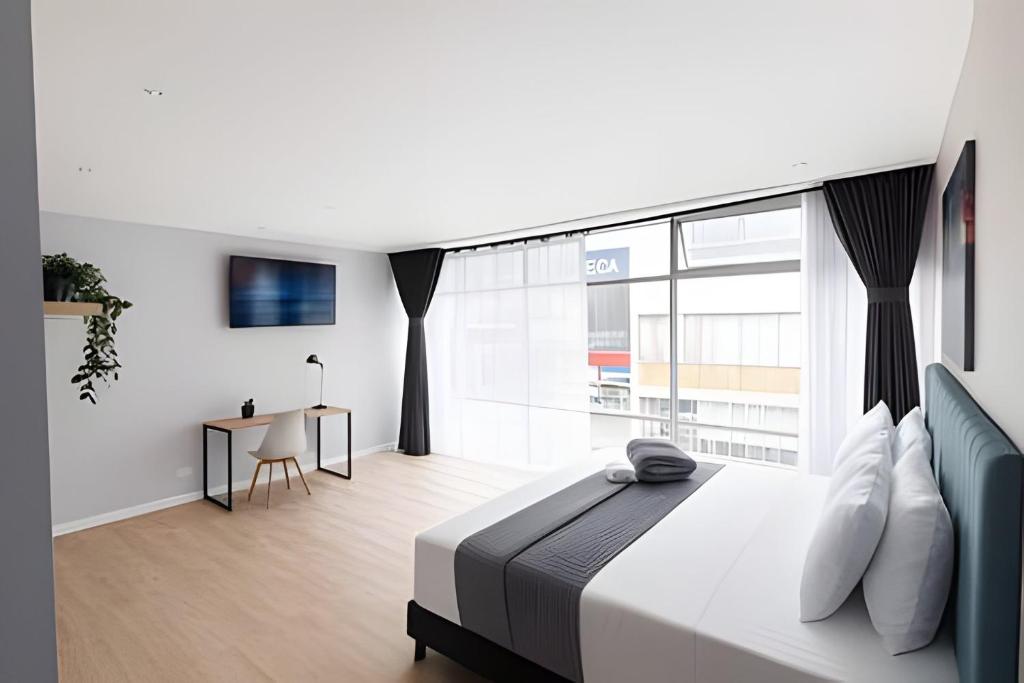 Postel nebo postele na pokoji v ubytování Luxury Apartaestudio Chapinero
