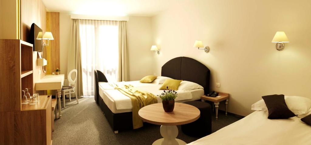 A bed or beds in a room at Hotel Mirna - Terme & Wellness Lifeclass