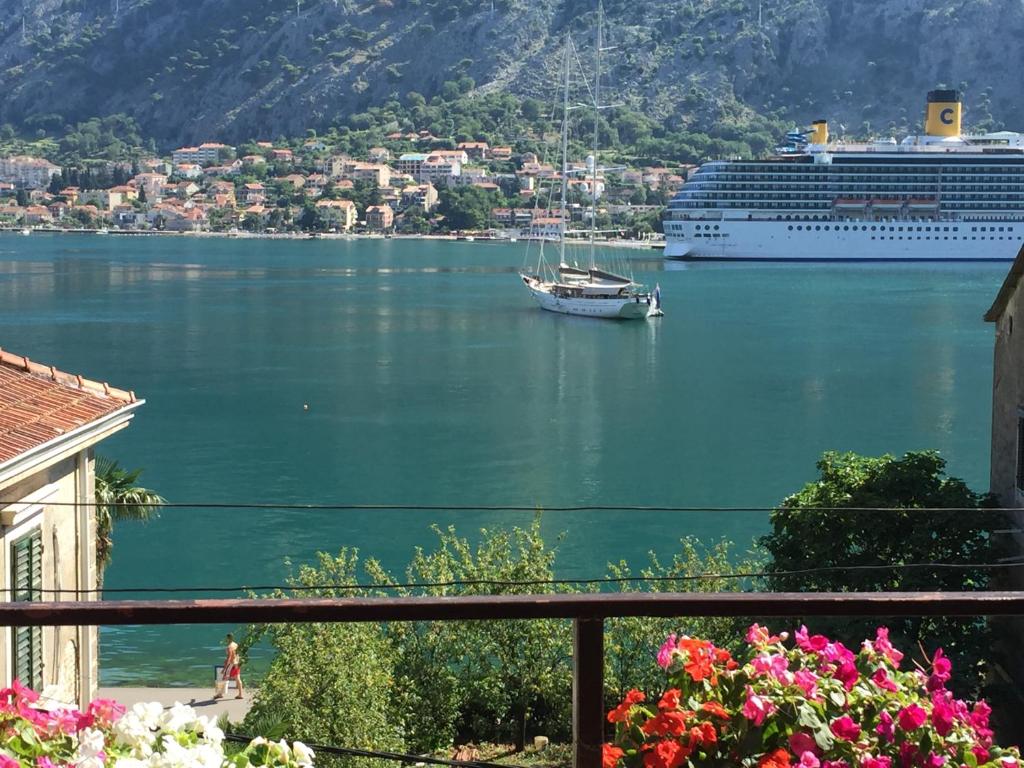 a cruise ship in a body of water with a boat at Apartment Lima in Kotor