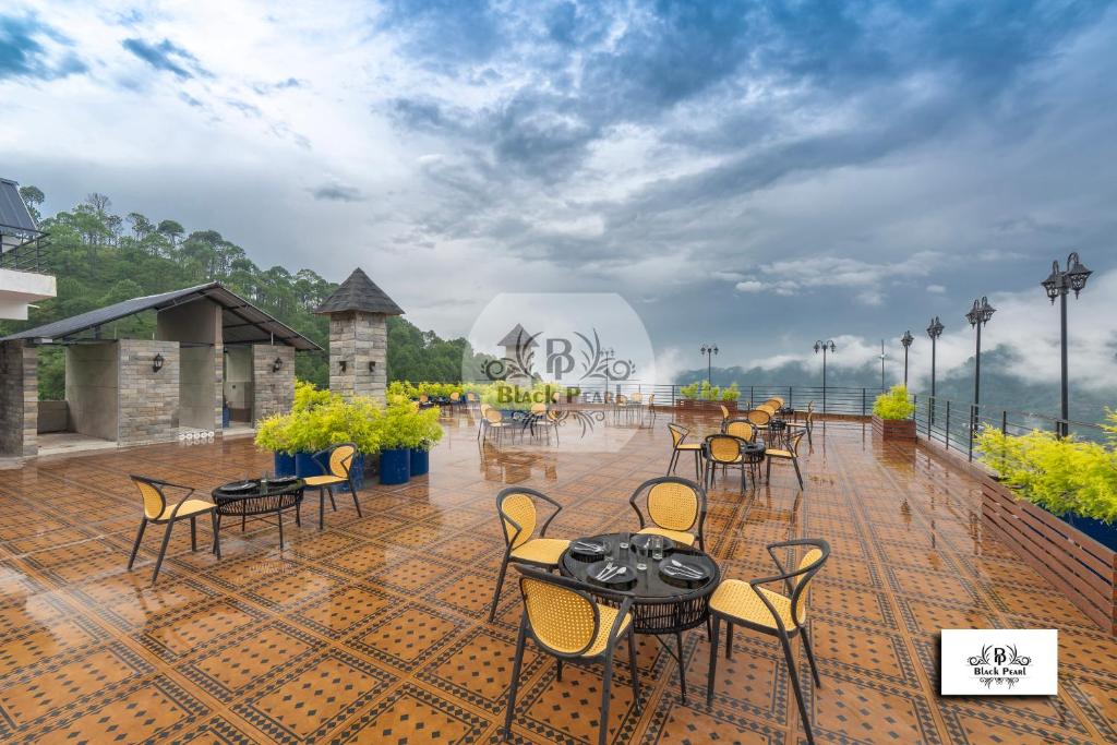 a group of tables and chairs on a patio at Maverick Hills Kasauli in Kasauli