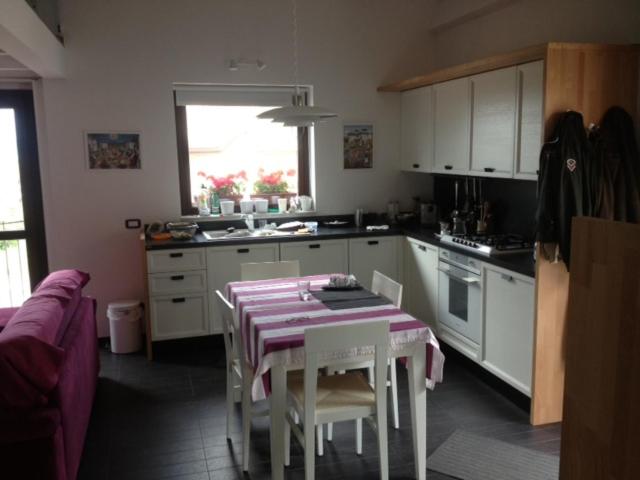 a kitchen with a table and chairs in a kitchen at Villa Parco La Collina in Alfedena