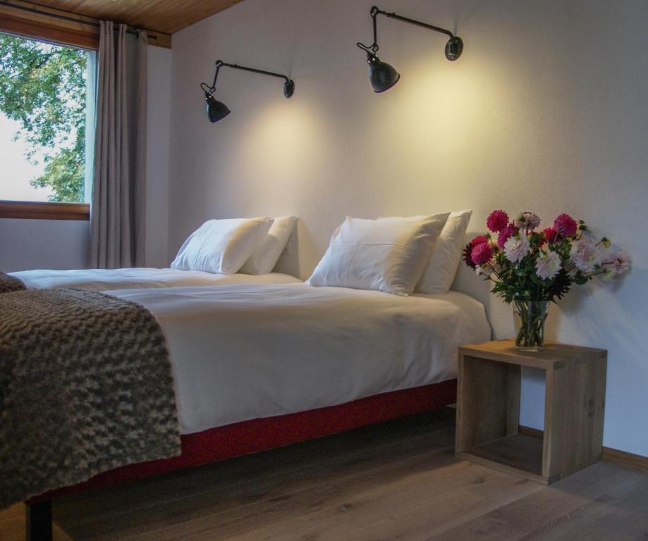 Postel nebo postele na pokoji v ubytování La Ferme du Lignon