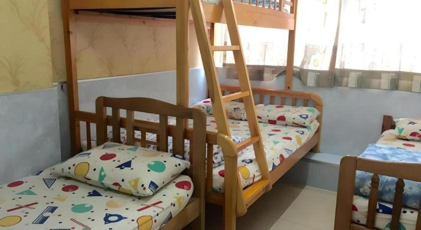 Ένα ή περισσότερα κρεβάτια σε δωμάτιο στο Dragon Hostel Hong Kong