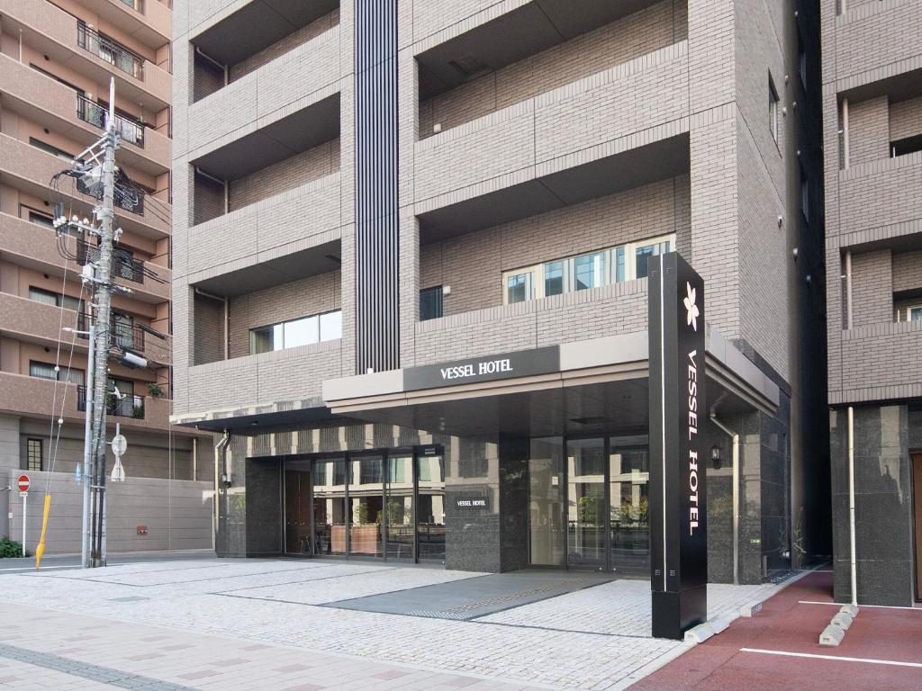 a building with a west link sign in front of it at Vessel Hotel Hiroshima Peace Blvd in Hiroshima