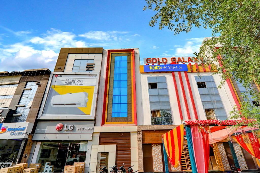 a building with a god family job corps sign on it at FabHotel Gold Galaxy in Kānpur