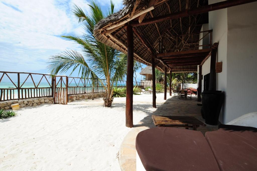 a resort patio with a view of the beach at Beachfront Villa Patti ZanzibarHouses in Kiwengwa