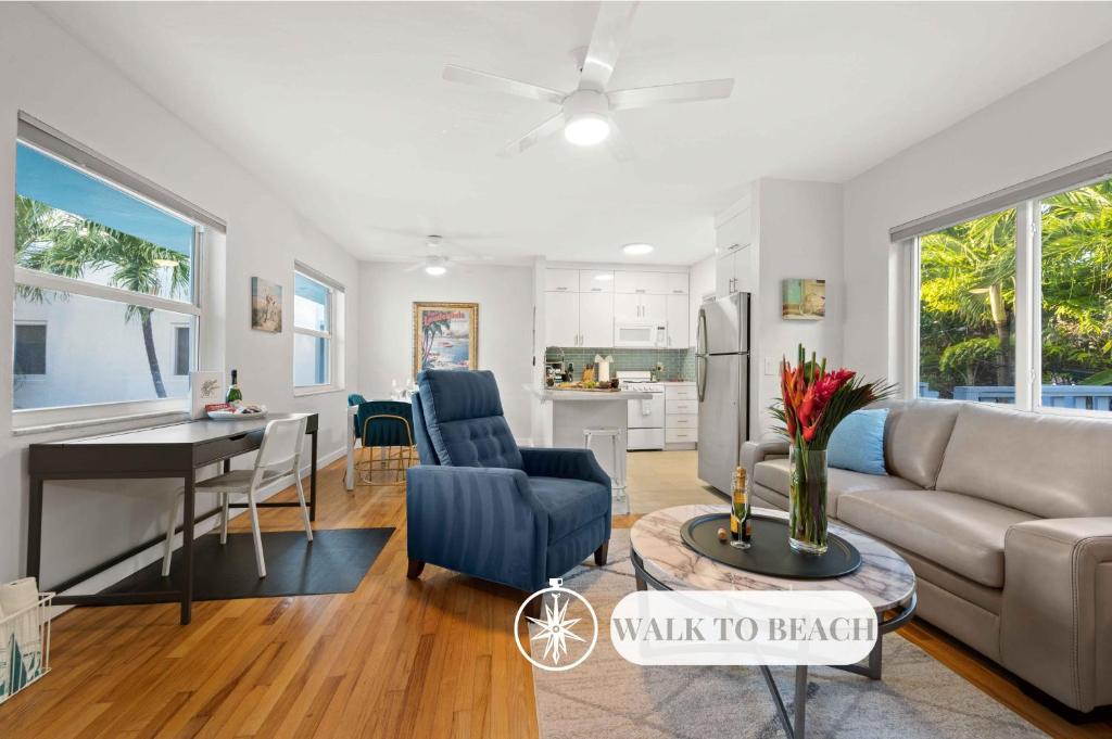 a living room and kitchen with a couch and a table at Condo by the Beach King Bed Lush Patio w BBQ Breakers Key Six H0MES in Fort Lauderdale