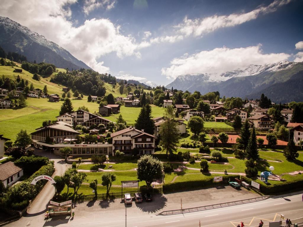 a town in a valley with mountains in the background at Hotel Sport Klosters in Klosters
