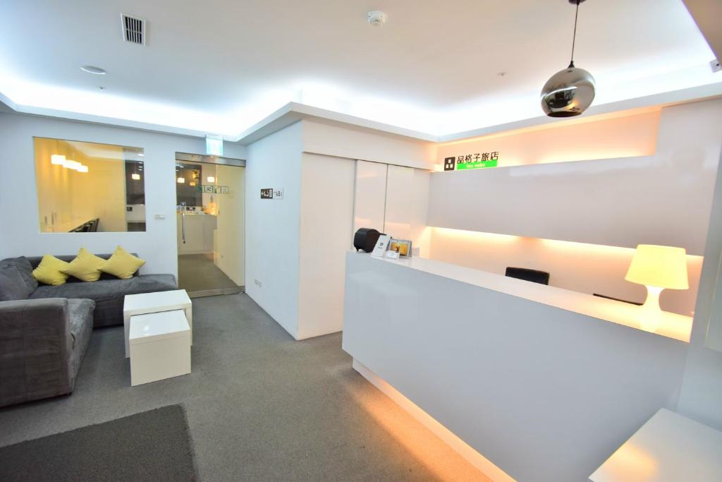 a living room with a couch and a table at Inn Cube - Ximen in Taipei
