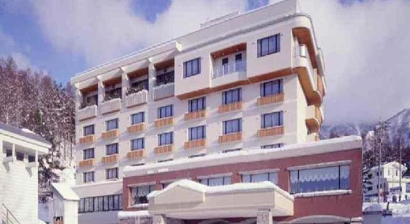 a large white building with a lot of windows at Hotel North Shiga in Shimotakai