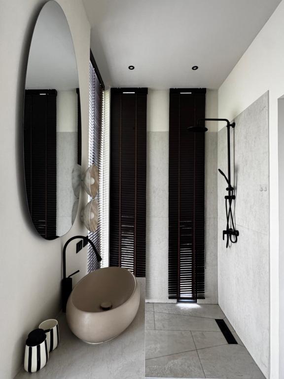 a bathroom with a round tub and a mirror at Siam Residence - Modern Villa with a Private Pool in Koh Phangan