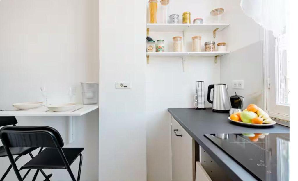 a kitchen with a counter with a bowl of fruit at Lovely room in Nice in Nice