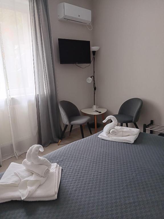 a bedroom with a bed with towels on it at Dulce Luna in Bucharest