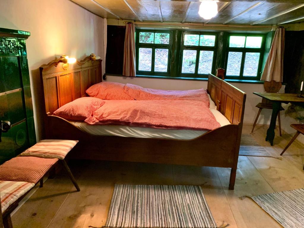 a bedroom with a large bed with red sheets at Ferienhaus Hederle in Elzach
