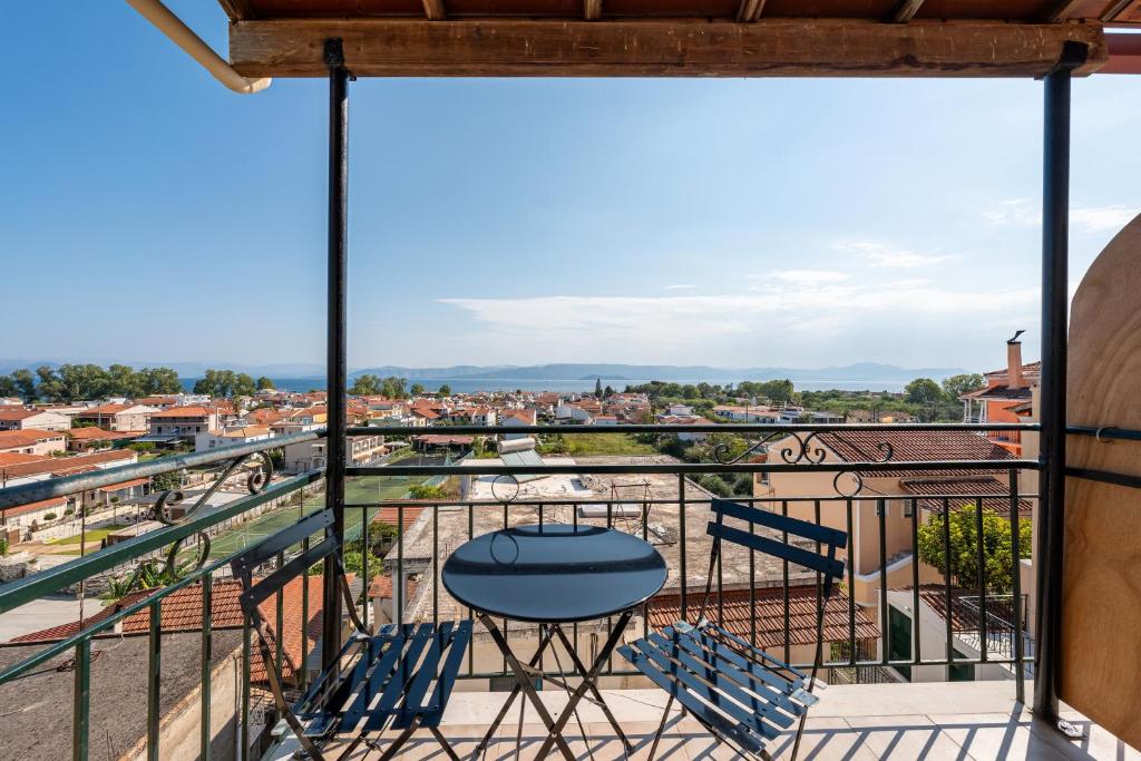 a balcony with chairs and a table and a view at Gavriil Maisonette G3 in Corfu