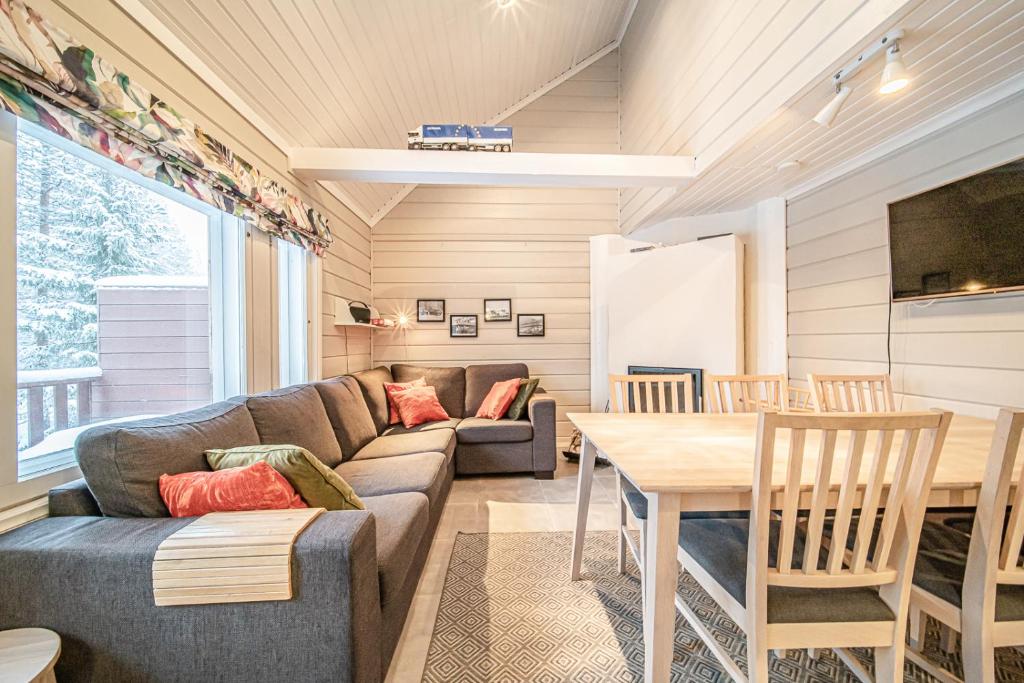 a living room with a couch and a table at Lavi Chalet by Aavalevi in Levi