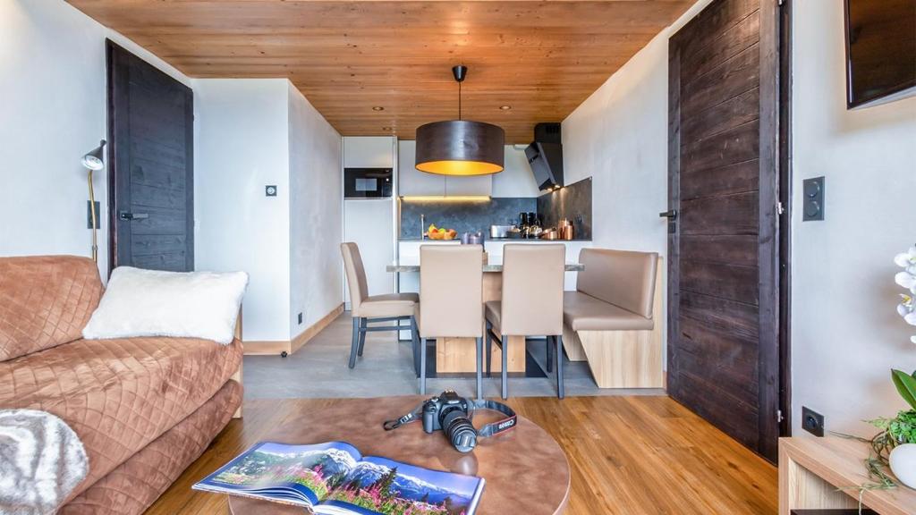 a living room with a couch and a table at ASAI210-5-2 Appartement-4 étoiles Les Saisies - 6 personnes in Les Saisies