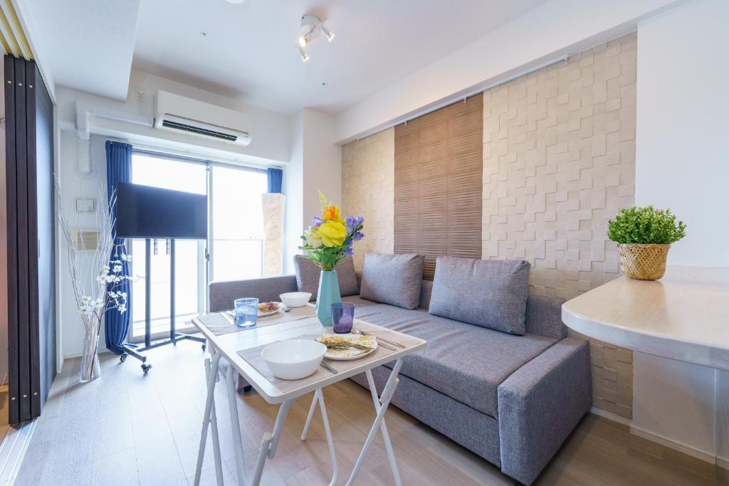 a living room with a couch and a table at 20 min to Nagoya Station Luxury Apt 4pax 2 1bed in Nagoya