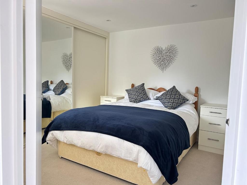 a bedroom with a bed and a large mirror at Private Garden Retreat 2BR Modern Comfort in Emsworth