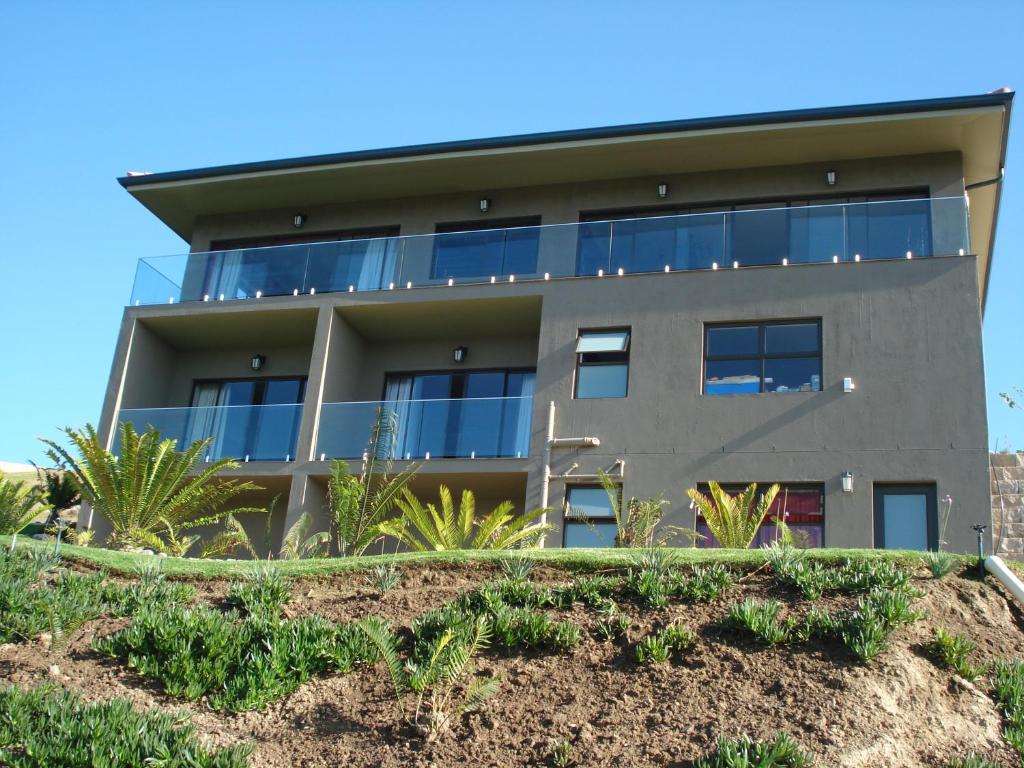 an apartment building on a hill with plants at W21 in Groot Brak Rivier