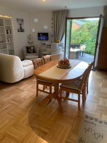 a living room with a wooden table and a couch at Les Quatre Saisons in Vresse-sur-Semois
