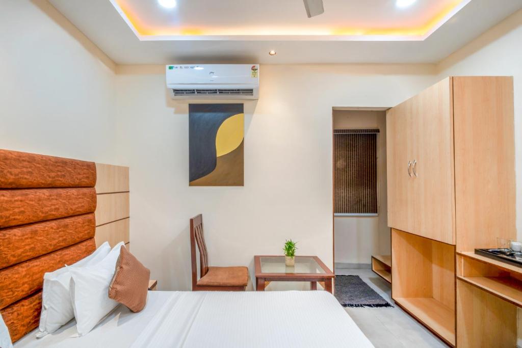 a bedroom with a bed and a desk and a chair at Hotel Clover Inn by Onyx Group in Indore