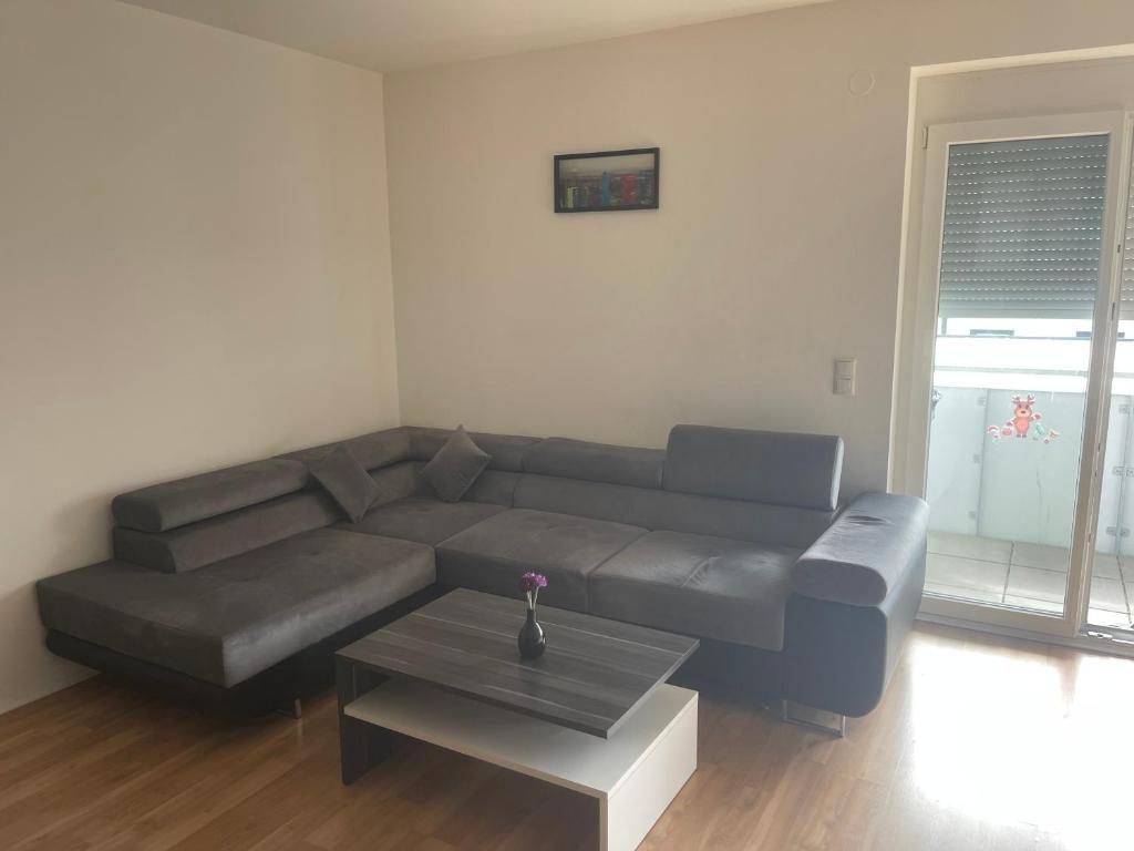 a living room with a couch and a coffee table at Schöne Wohnung in Korneuburg